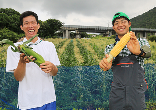 トウモロコシの朝採れ直売会を始める榊原昂輝さん(左)と小川敬生さん