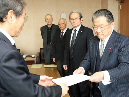 議員定数削減の要望書を提出する睦谷博・市自治会連合会長(右)