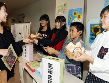 「大切に育ててください」とヒマワリの種を配った城西小児童