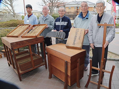 昭和の大嘗祭に乾鯛を献上した際の道具一式を寄贈した今井宏明さん=右から2人目=と「尾崎を語る会」のみなさん